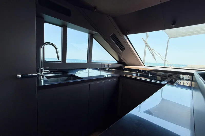 Amy Yacht Photos Pics Modern kitchen interior of 2023 Cranchi Sessantasette 67 yacht with sleek design and ocean view.