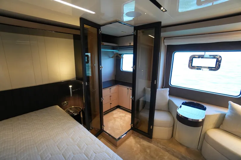Amy Yacht Photos Pics Luxurious interior of 2023 Cranchi Sessantasette 67 yacht with elegant furnishings and large window.