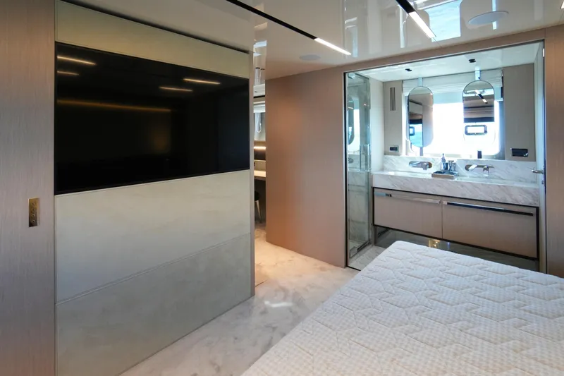 Amy Yacht Photos Pics Luxurious interior of 2023 Cranchi Sessantasette 67 yacht, featuring modern bedroom and bathroom design.