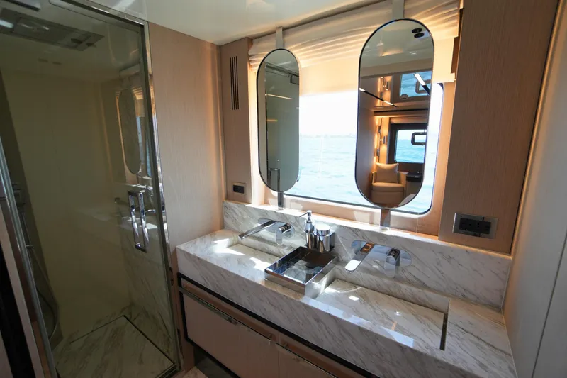 Amy Yacht Photos Pics Luxurious bathroom in 2023 Cranchi Sessantasette 67 yacht with marble sink and modern fixtures.