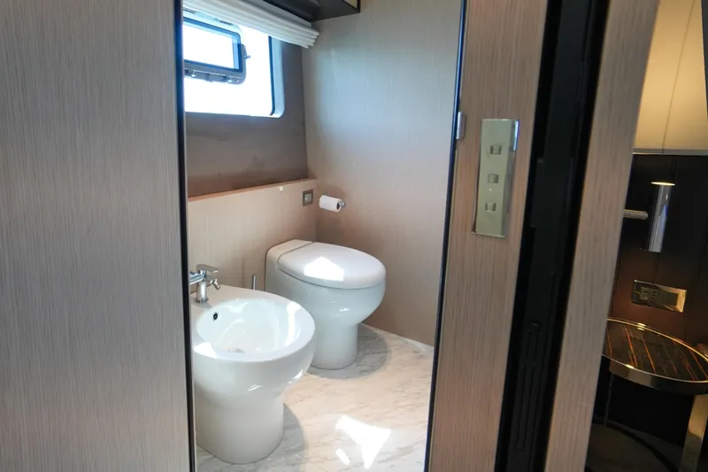 Amy Yacht Photos Pics 2023 Cranchi Sessantasette 67 yacht bathroom with modern fixtures and natural lighting.