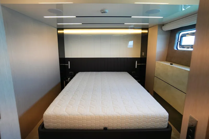 Amy Yacht Photos Pics Luxurious bedroom interior of 2023 Cranchi Sessantasette 67 yacht with modern design and window view.