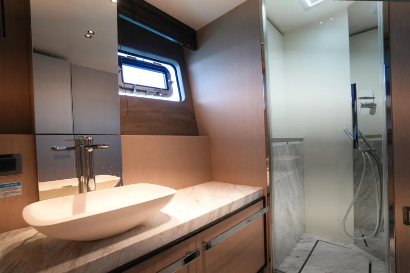 Amy Yacht Photos Pics Luxurious bathroom in 2023 Cranchi Sessantasette 67 yacht with modern sink and shower.