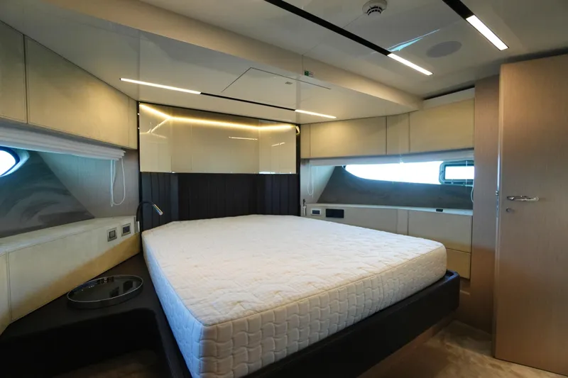 Amy Yacht Photos Pics Luxurious bedroom interior of 2023 Cranchi Sessantasette 67 yacht, featuring modern design and ambient lighting.