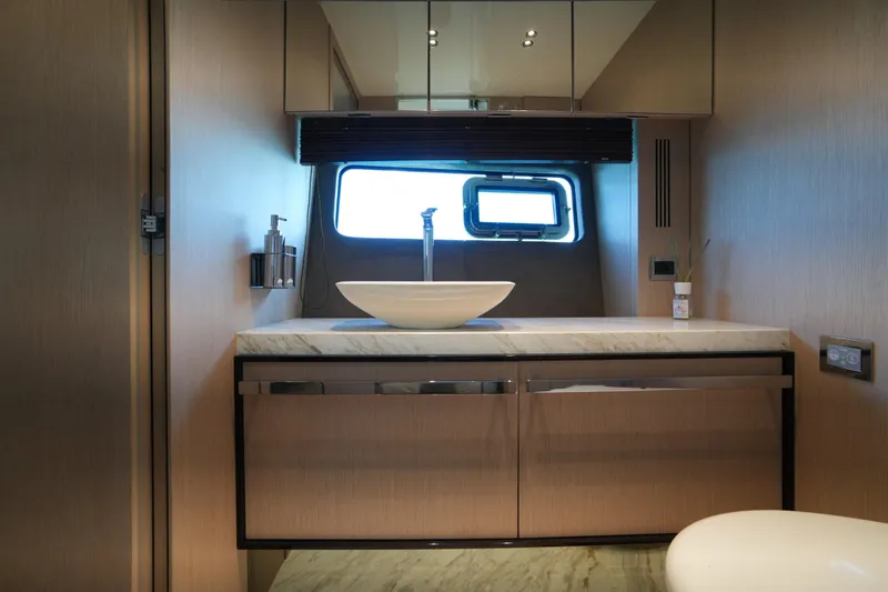 Amy Yacht Photos Pics Luxurious bathroom interior of 2023 Cranchi Sessantasette 67 yacht with modern fixtures.