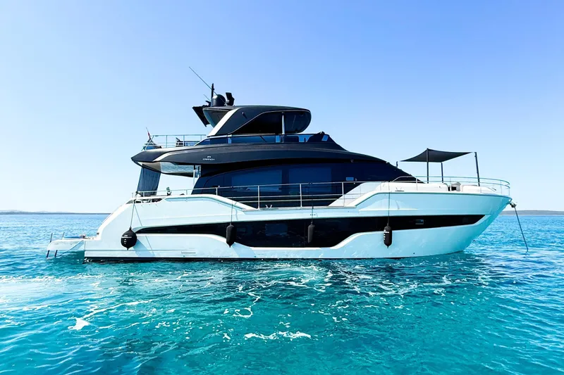 Amy Yacht Photos Pics 2023 Cranchi Sessantasette 67 yacht on clear blue water under a bright sky.