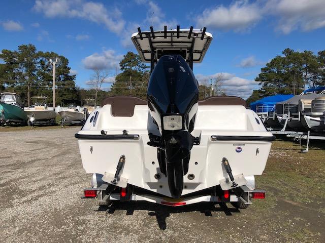 2024 Reflex Gladiator boat with outboard motor on trailer, parked outdoors.