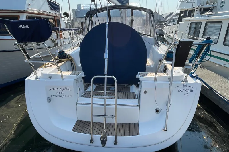 Jaacktak Yacht Photos Pics 2004 Dufour 40 Performance sailboat docked, rear view with ladder and cockpit cover.