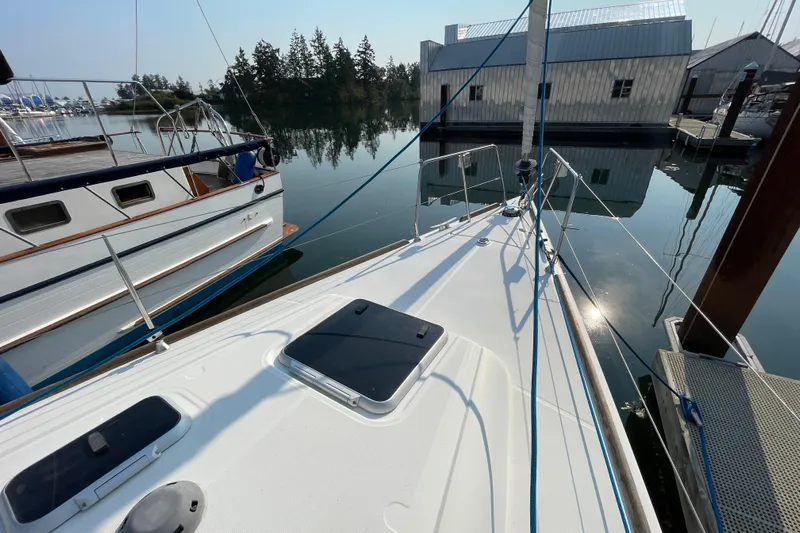 Jaacktak Yacht Photos Pics 2004 Dufour 40 Performance sailboat docked in a serene marina setting.