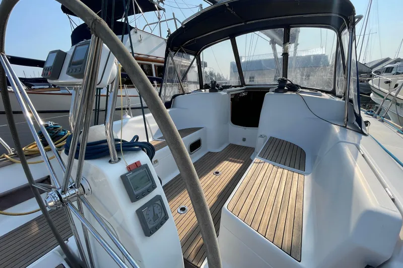 Jaacktak Yacht Photos Pics Cockpit of 2004 Dufour 40 Performance sailboat with wooden seating and navigation instruments.