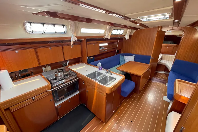Jaacktak Yacht Photos Pics Interior of 2004 Dufour 40 Performance yacht with kitchen and seating area.