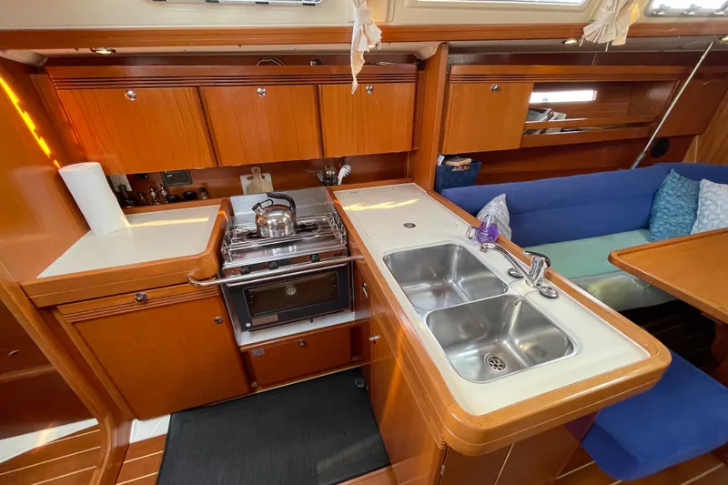Jaacktak Yacht Photos Pics 2004 Dufour 40 Performance yacht kitchen with stove, sink, and seating area.