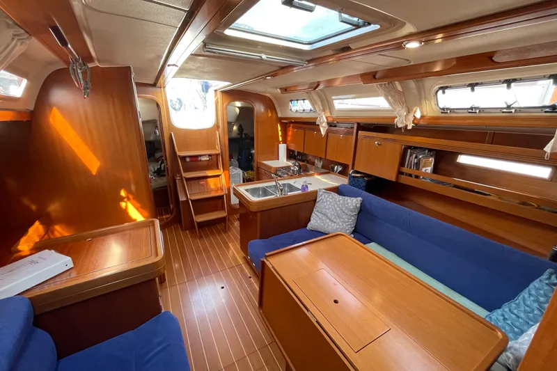 Jaacktak Yacht Photos Pics Interior of 2004 Dufour 40 Performance yacht with wooden finish and blue seating.
