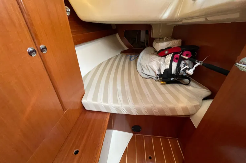 Jaacktak Yacht Photos Pics Cozy cabin interior of 2004 Dufour 40 Performance sailboat with striped mattress.