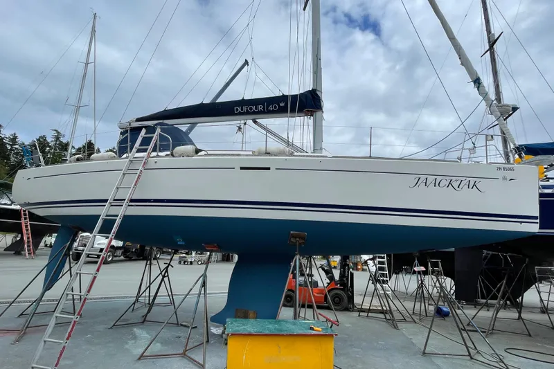 Jaacktak Yacht Photos Pics 2004 Dufour 40 Performance sailboat on dry dock, with blue hull and white deck.