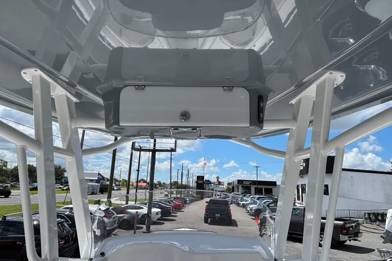  Yacht Photos Pics 2026 Glasstream 280 Pro-XS boat interior view with overhead storage and dealership background.