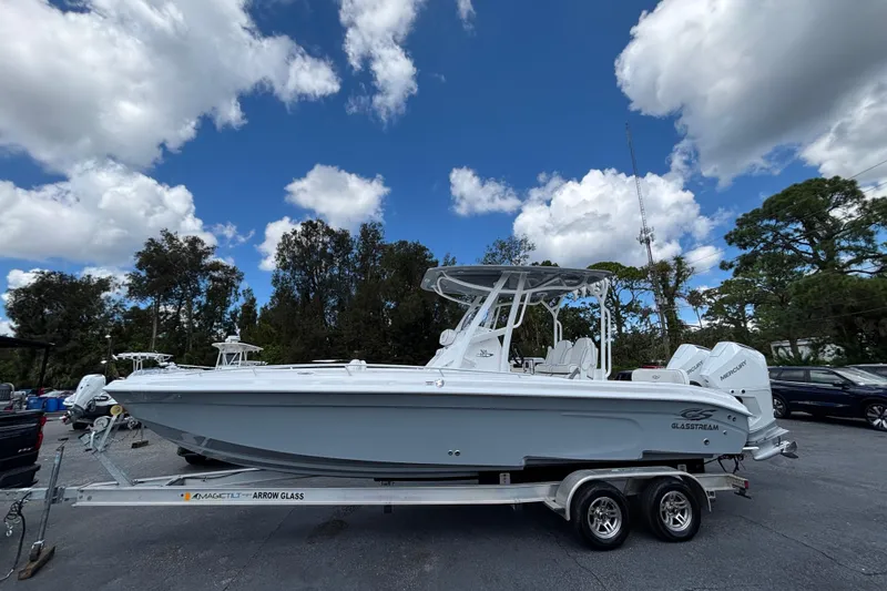  Yacht Photos Pics 2026 Glasstream 280 Pro-XS boat on trailer under blue sky with clouds.