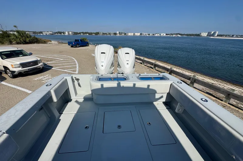 Free Spear It Yacht Photos Pics 2016 Contender 35 ST boat with dual engines at a scenic waterfront dock.