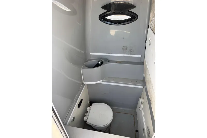 Free Spear It Yacht Photos Pics 2016 Contender 35 ST boat interior bathroom with compact toilet and sink.
