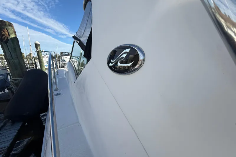  Yacht Photos Pics 2005 Sea Ray 390 Sundancer yacht docked at marina, side view with logo.