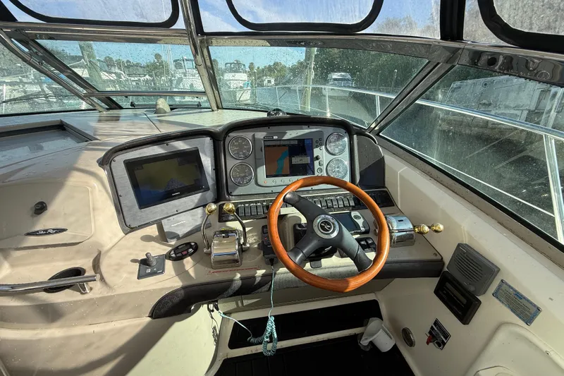  Yacht Photos Pics Helm of 2005 Sea Ray 390 Sundancer with navigation equipment and wooden steering wheel.