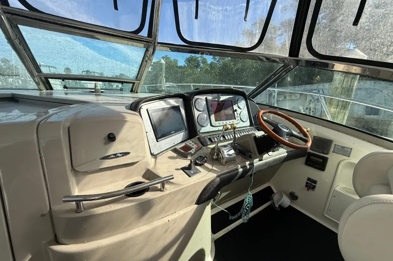 Yacht Photos Pics 2005 Sea Ray 390 Sundancer helm with navigation controls and steering wheel.