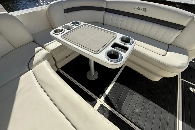  Yacht Photos Pics 2005 Sea Ray 390 Sundancer interior with cushioned seating and table with cup holders.