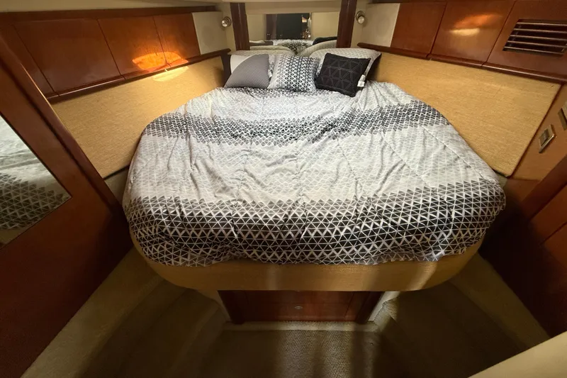  Yacht Photos Pics Cozy bedroom interior of 2005 Sea Ray 390 Sundancer yacht with patterned bedding.