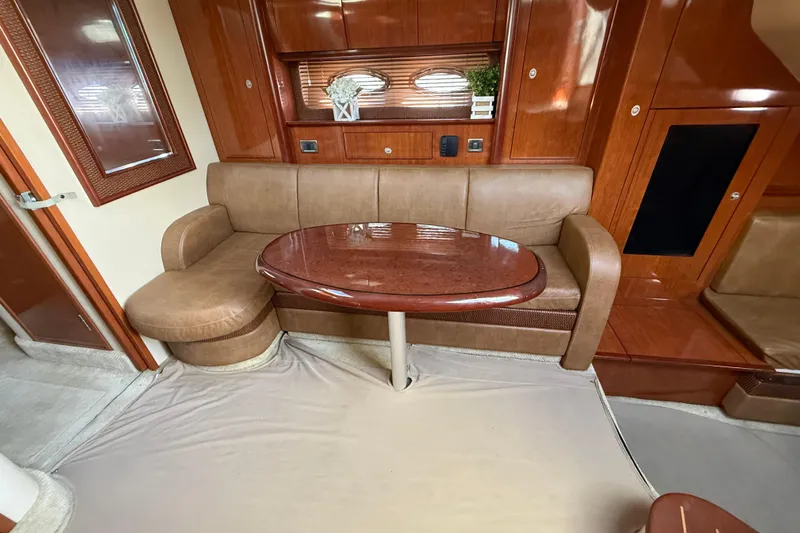  Yacht Photos Pics Luxurious interior of 2005 Sea Ray 390 Sundancer with elegant wood finishes and plush seating.