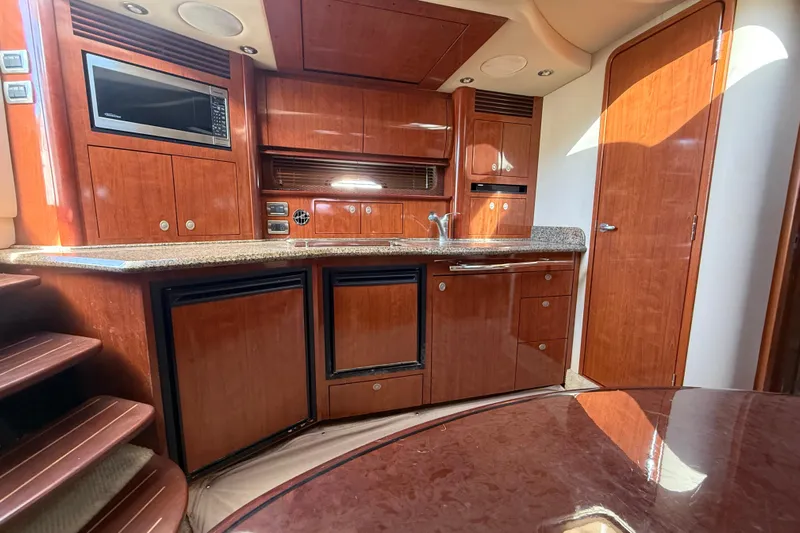  Yacht Photos Pics 2005 Sea Ray 390 Sundancer interior with wood cabinetry and modern kitchen amenities.