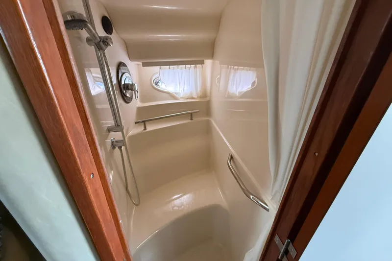  Yacht Photos Pics Shower area in 2005 Sea Ray 390 Sundancer yacht with curtain and porthole window.