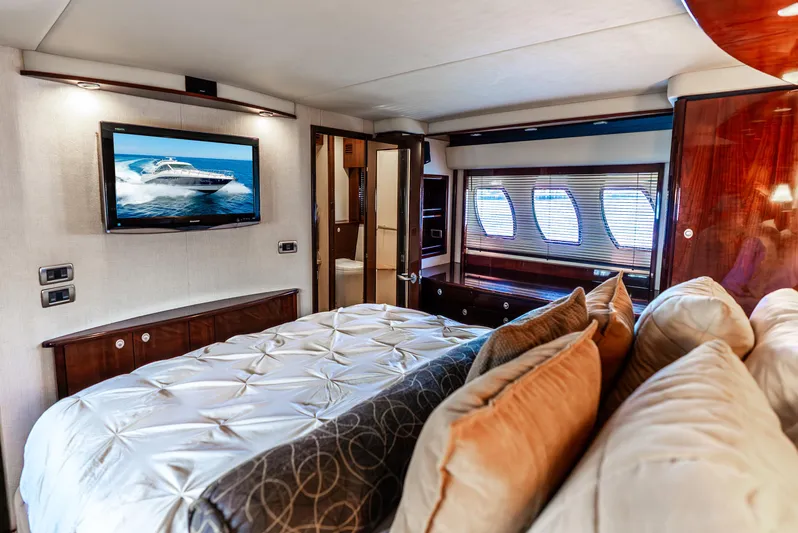 Brinee Yacht Photos Pics Luxurious bedroom interior of 2008 Sea Ray 60 Sundancer yacht with TV and plush bedding.