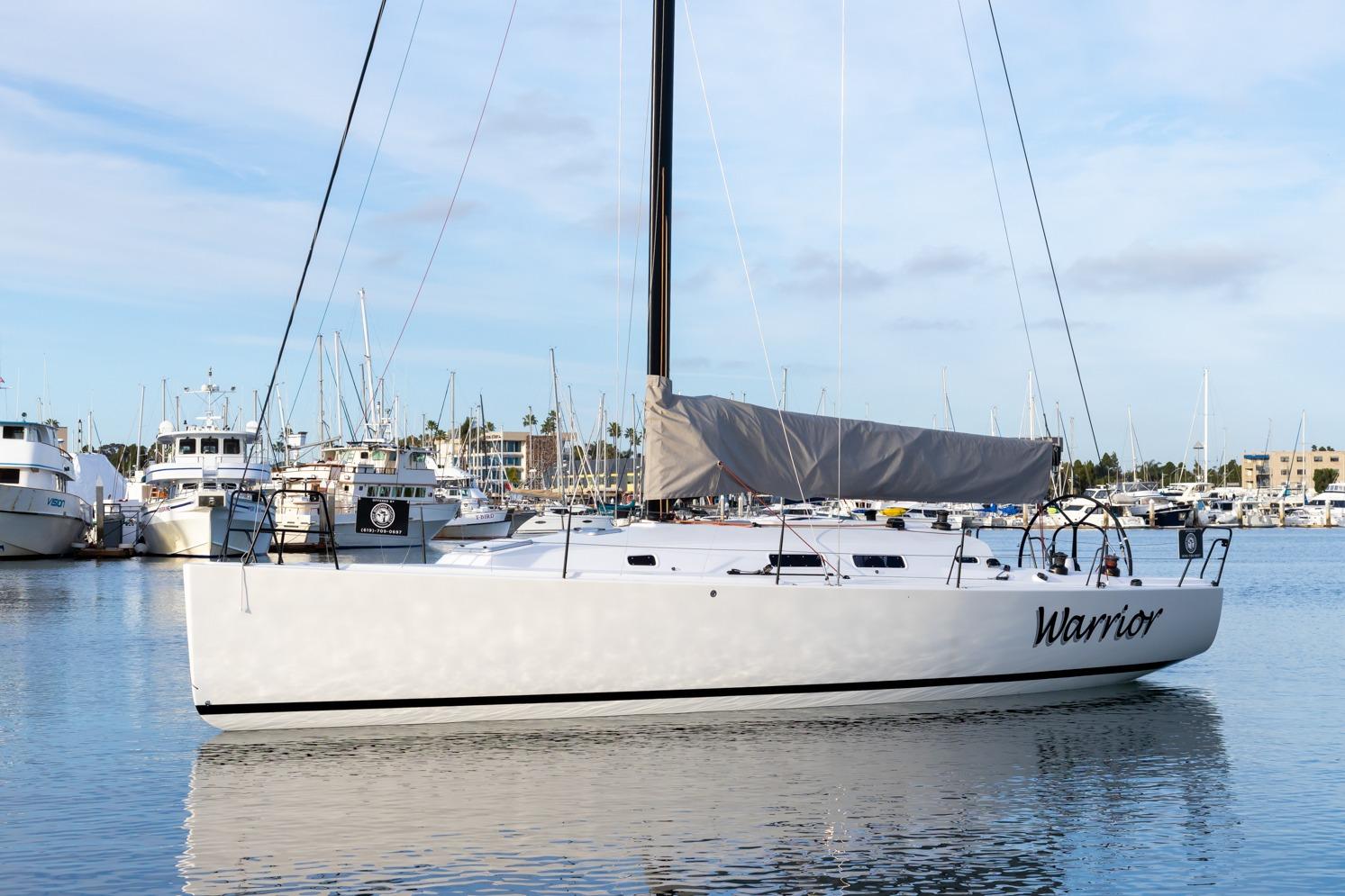 2008 J Boats J/122 sailboat named "Warrior" docked in a marina.