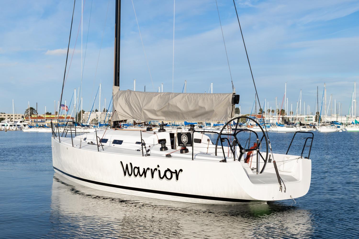 2008 J Boats J/122 sailboat named "Warrior" docked in a marina.