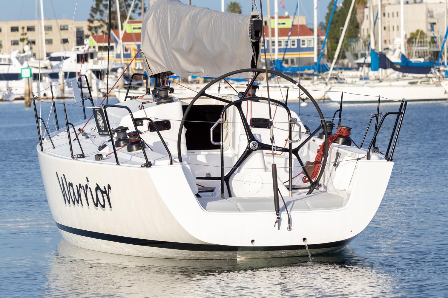 2008 J Boats J/122 sailboat named Warrior docked in a marina.