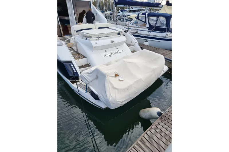  Yacht Photos Pics 2008 Sunseeker Predator 52 yacht docked at marina, rear view with covered equipment.