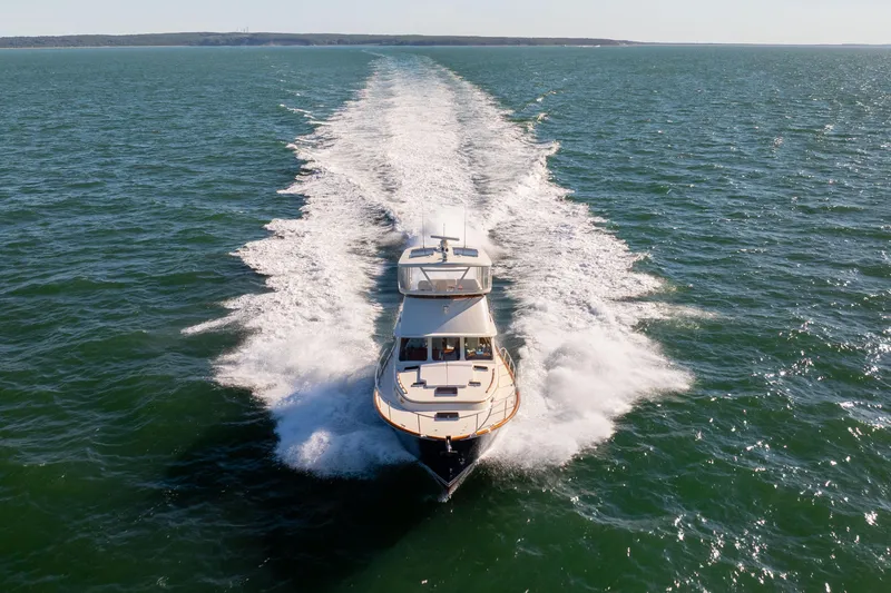 Barefoot Yacht Photos Pics 2014 Hinckley Talaria 48 Flybridge cruising on open water, leaving a wake.
