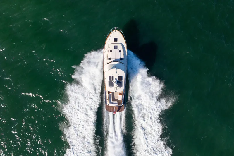 Barefoot Yacht Photos Pics Aerial view of 2014 Hinckley Talaria 48 Flybridge yacht cruising on open water.