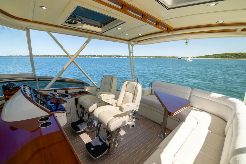 Barefoot Yacht Photos Pics Luxurious interior of 2014 Hinckley Talaria 48 Flybridge yacht with scenic ocean view.