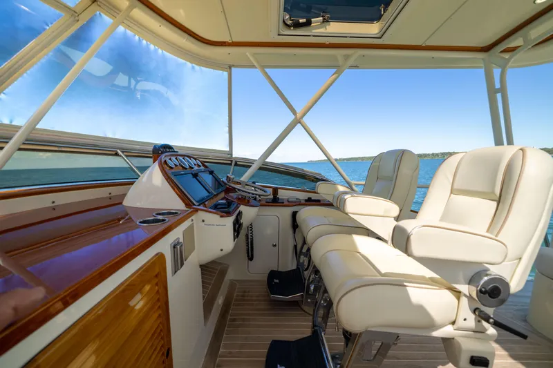Barefoot Yacht Photos Pics Flybridge interior of 2014 Hinckley Talaria 48, featuring luxurious seating and navigation controls.
