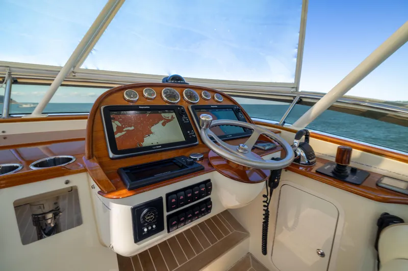 Barefoot Yacht Photos Pics Helm of 2014 Hinckley Talaria 48 Flybridge with navigation system and controls.