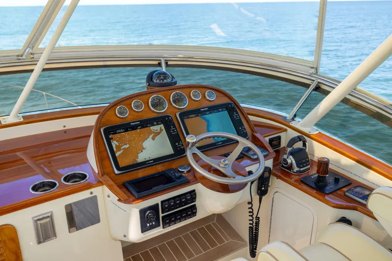 Barefoot Yacht Photos Pics Helm of 2014 Hinckley Talaria 48 Flybridge with navigation screens and ocean view.