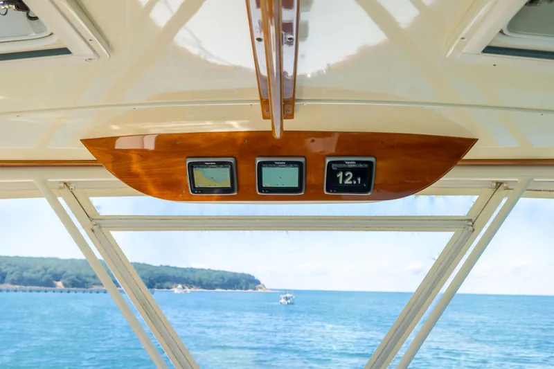 Barefoot Yacht Photos Pics Hinckley Talaria 48 Flybridge 2014 dashboard with navigation screens, overlooking ocean view.