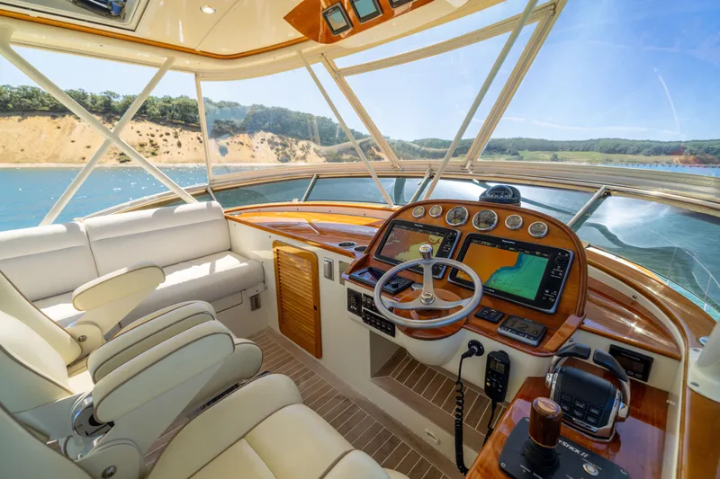 Barefoot Yacht Photos Pics 2014 Hinckley Talaria 48 Flybridge helm with luxurious seating and advanced navigation systems.