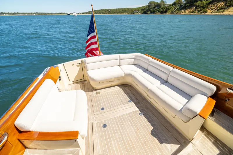 Barefoot Yacht Photos Pics Hinckley Talaria 48 Flybridge 2014 yacht deck with seating, American flag, and scenic water view.