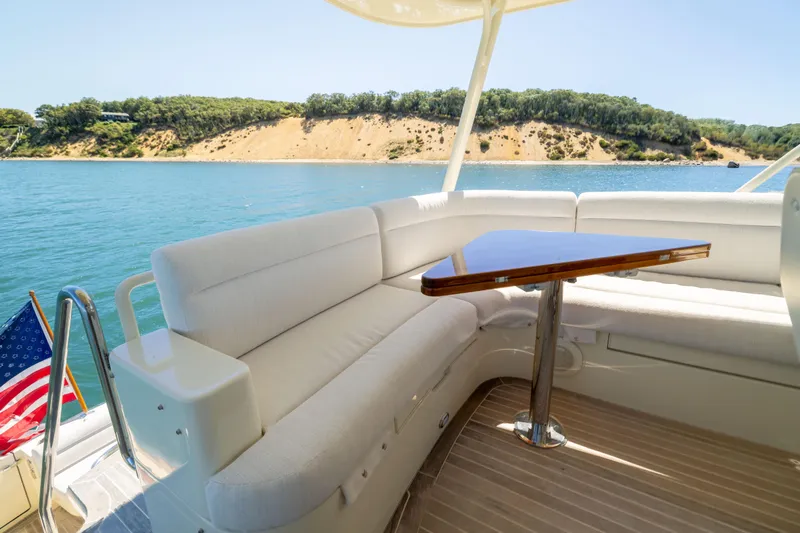 Barefoot Yacht Photos Pics Luxurious 2014 Hinckley Talaria 48 Flybridge yacht with elegant seating and scenic water view.