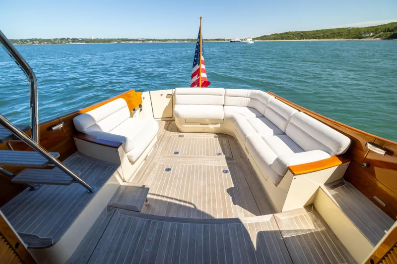 Barefoot Yacht Photos Pics 2014 Hinckley Talaria 48 Flybridge yacht with spacious deck seating and American flag.