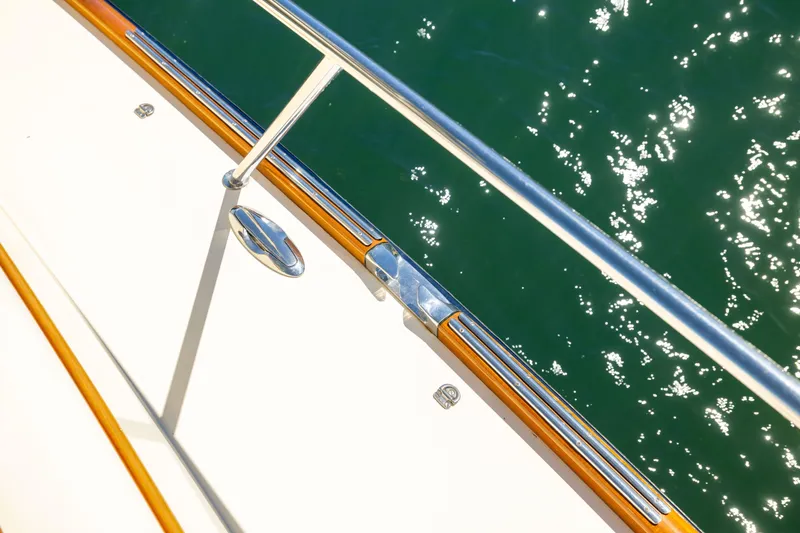 Barefoot Yacht Photos Pics Hinckley Talaria 48 Flybridge 2014 yacht deck with polished railing over sparkling water.