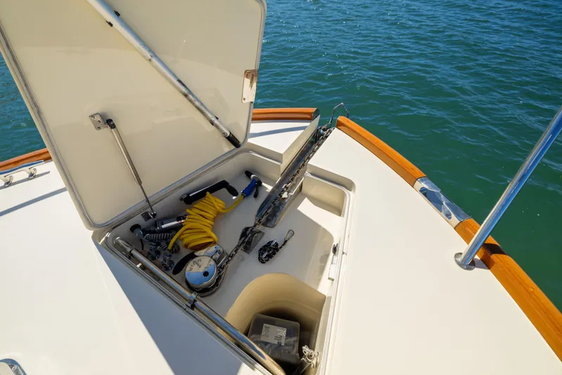 Barefoot Yacht Photos Pics Open storage compartment on 2014 Hinckley Talaria 48 Flybridge yacht, with marine equipment visible.