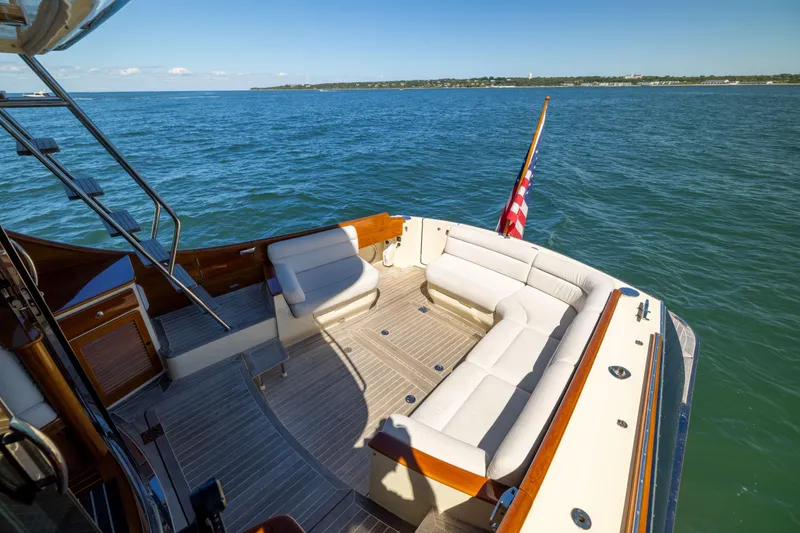 Barefoot Yacht Photos Pics Hinckley Talaria 48 Flybridge 2014 yacht with spacious deck and seating, cruising on open water.